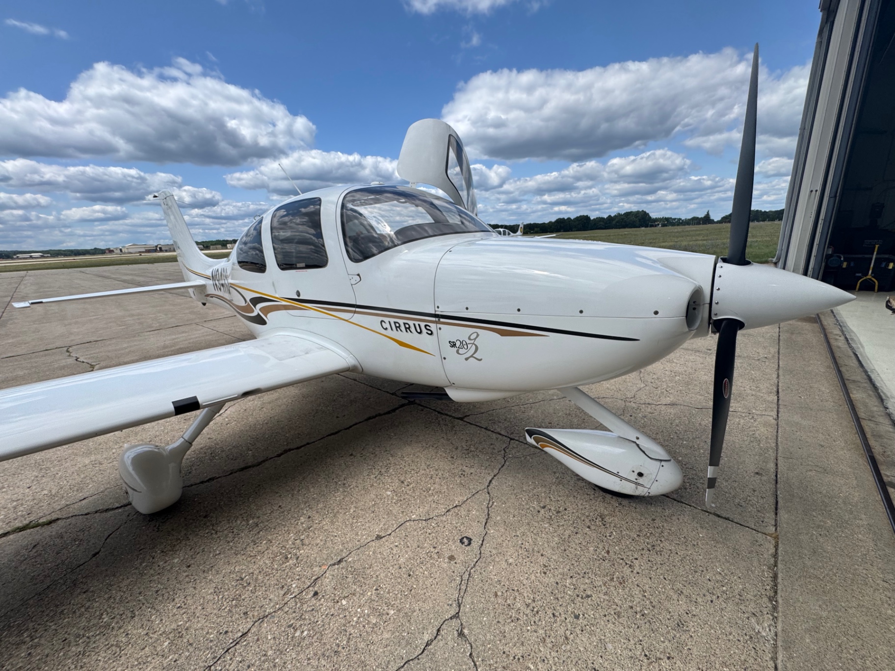 Cirrus SR20-G2 nosed out of the hangar door